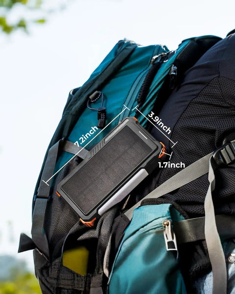 Solar Power Bank With Hand Crank And Four Cables 20000mAh Wireless Portable Charger on a backpack outdoors