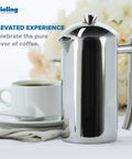Double Walled Stainless Steel French Press Coffee Maker 44 Oz Extra Large Polished, side view with coffee cup and saucer