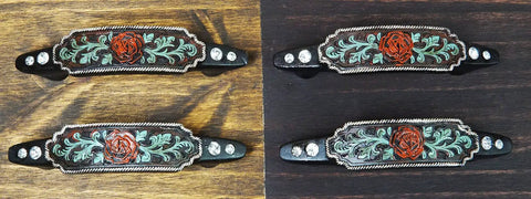 Hella Charismatic Six Inch Wide Set Of Four Western Red Rose Cabinet Pulls With Sweeping Green Vine And Lush Scroll Detailing Hand Cast Resin Drawer Handles Rustic Weathered Finish Kitchen Hardware displayed on wood.