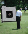Golfer using 57 Inch Silent Golf Practice Net With Colorful Target Cloth For Indoor And Outdoor Training in backyard