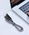 Heavy Duty Six Point Six Foot Two Prong AC Power Cord Seven Amps 125 Volts 18 AWG Replacement Cable next to a laptop
