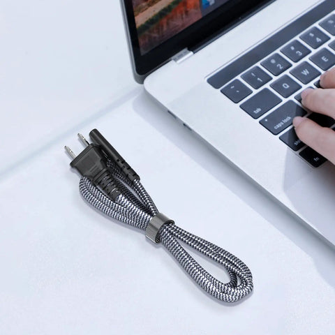Heavy Duty Six Point Six Foot Two Prong AC Power Cord Seven Amps 125 Volts 18 AWG Replacement Cable next to a laptop