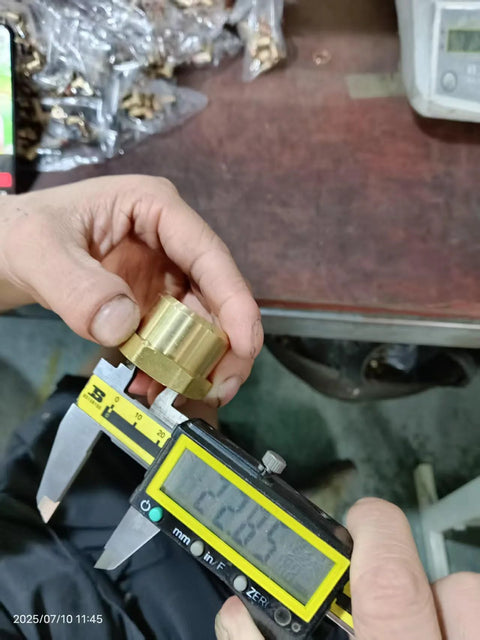Brass 3/4 in NPT female pipe cap with hex head, hand-held close-up.
