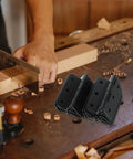 10-pack black iron cabinet box hinges on a woodworking bench with wood shavings.