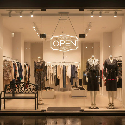 Lit Neon Open Sign For Business With Dimmable LED Warm White Glow, hanging in a storefront window, bright visibility inside a clothing store.