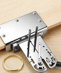 Stainless Steel Bench Vise For Jewelry Making And Metalworking with adjustable clamps, holding tools on a wooden surface.