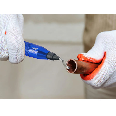 Close-up of blue deburring tool with curved blade deburring copper pipe, gloved hands.