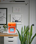 No Sweat Contactless Time Clock For Small Business Automated Payroll Tracker on a desk with plants and decor.
