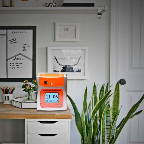 No Sweat Contactless Time Clock For Small Business Automated Payroll Tracker on a desk with plants and decor.