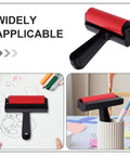 Solid Grip Rubber Paint Roller For Printmaking And Classroom Art Projects on a drawing table with art supplies.