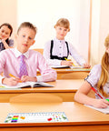 Students in classroom using 40 Pcs Transparent Desk Nameplate Pockets 12.5 X 4.5 Inch Self Adhesive, 7 Mil Thickness for neat setup