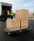Heavy Duty 2000 Lb Moving Dolly, Adjustable Furniture Transport Cart With Telescoping Base And Sturdy Steel Frame For Boss Moves, loaded with cardboard boxes.