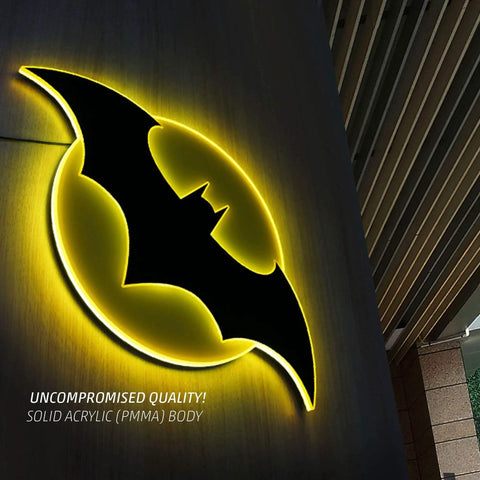 Batman Night Light Table Lamp With 3D Halo Glow mounted on wall, black bat emblem with yellow glow, solid acrylic material.