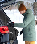 Legit Tesla Level One And Two Ev Charger Featuring Nacs Connector And ETL Certified in use, being stored in car trunk during winter.