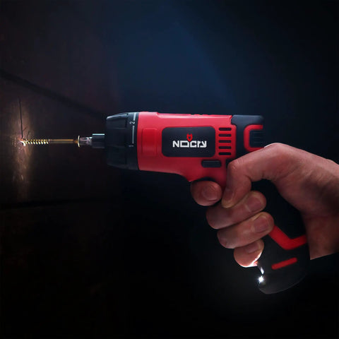 Cordless Electric Screwdriver Kit With Built In LED Light And 31 Pc Bit Set being used to drive a screw into wood, LED light on.