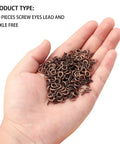 Heavy Duty Red Copper Plated Screw Eye Pin Hooks in hand, 200 piece bulk pack for DIY projects, size 7x14mm.