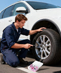 Man using Premium Spiral Screw Tire Repair Kit With 61 Heavy Duty Rubber Plugs on a car's tire for quick flat repairs.