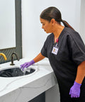 Person using Bleach Disinfecting Wipes For Hospital Grade Surface Cleaning In Bathrooms And Equipment on a sink