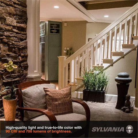 Cozy living space with Sylvania Slim Microdisk Downlight, 12W, 5 CCT Select (2700K - 5000K) recessed lighting, and comfortable seating.