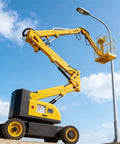 Heavy Duty Telescopic Boom Lift Electric Hydraulic Aerial Work Platform Compact Machine at work lifting near a street lamp.