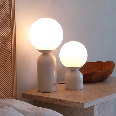 10 Inch Table Lamp With Marble Base And Frosted Glass Shade, Cozy Bedside Reading Light for Bedroom and Living Room, lit on a table