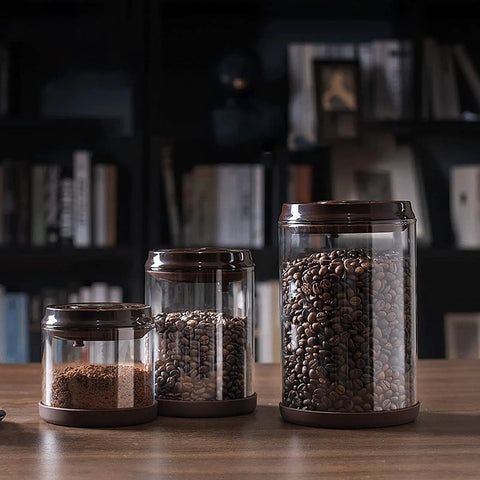 Round High Borosilicate Glass Coffee Bean Container With Real Deal Airtight Seal displaying three sizes filled with coffee and ground coffee.
