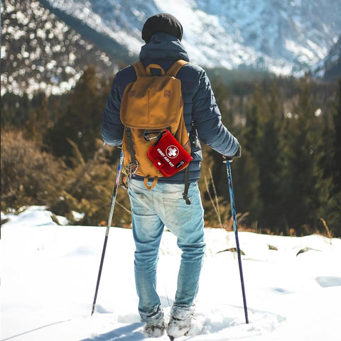 Benelinemed mini first aid kit, 137-piece red emergency kit attached to hiking backpack (back view)