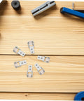6 Piece White Nylon Sliding Wheels For Furniture Drawers Slick Rolling Track Guide Casters Heavy Duty laid out on wooden surface.