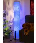 61 Inch Color Changing Floor Lamp With 3 Smart LED Bulbs illuminating blue light near a sofa and plant, creating cozy vibes