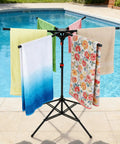 Outdoor Pool Towel Rack, Freestanding 42 to 71 Inch Adjustable Stand With Four Legs and Six Foldable Arms by poolside with towels
