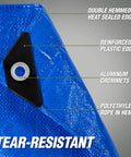Close-up of heavy duty waterproof tarp showing reinforced grommet and corner, highlighting tear-resistant material.