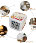 Slick Cube Digital Alarm Clock With Seven Color Led Night Light And Zero Hassle Snooze Buttons Time And Date Temperature Readout on a desk.