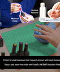 Hands using manicure tools on a chemical absorbent pad, showing manicured nails and acetone bottle, with protective gloves.