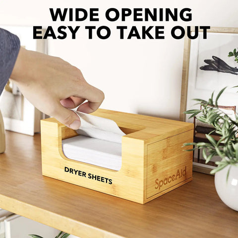 Person taking a sheet from Bamboo Dryer Sheet Holder With Opening And Labels For Easy Laundry Room Organization