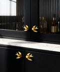 Solid Brass Gold Cabinet Knobs 4 Pack With Swallow Backplates on modern kitchen cabinets, brushed brass finish, installed view