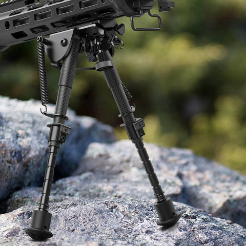 Carbon Fiber Bipod 6 To 9 Inches With M-Rail Adapter attached to rifle on rocks, showing lightweight and strong design