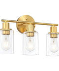 Gold three light vanity light with clear glass shades for a modern bathroom over mirror, ideal for bright task lighting and ambience.