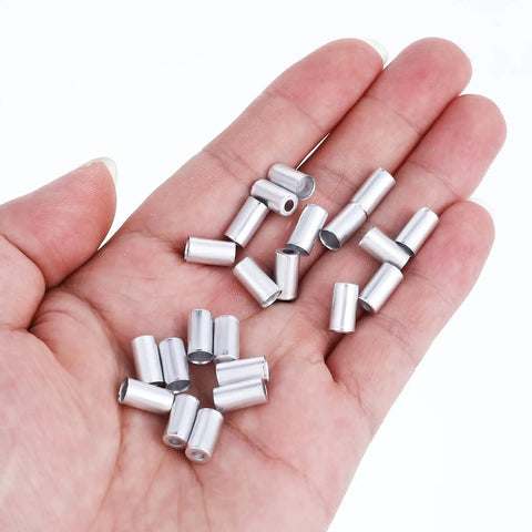 Hand holding 100 Pcs 5mm Bike Brake Cable Housing Ferrule End Caps And Crimps For Mountain And Road Bikes Must Have Silver Shifter Wire Housing Replacement Accessories Pack