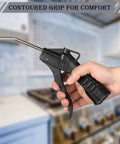 Hand holding 8 Piece Air Blower Nozzle Set With Pistol Grip For Compressor, black handle, contoured grip for comfort, in kitchen setting.