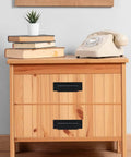 Wooden cabinet with set of 10 industrial cast iron drawer pulls in black, installed for vintage rustic kitchen hardware