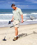Man using metal detector and Stainless Steel Sand Scoop For Metal Detecting With Long Handle Pole Durable Beach Sand Shovel on beach