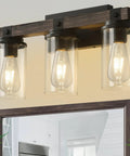 Rustic Farmhouse Vanity Light Fixture Over Mirror Three Light Industrial Matte Black Wall Sconces With Wood Accents And Clear Glass Shades in bathroom setting