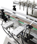 Close-up of Desktop four head magnetic pump on Automatic Liquid Filling And Bottle Capping Sealer Machine.