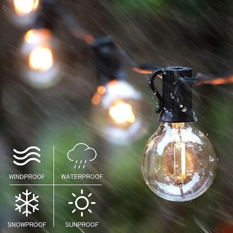 Solar Outdoor String Lights 100 Ft Shatterproof LED Patio Lights with waterproof symbols, glowing bulbs in rain, close-up view.