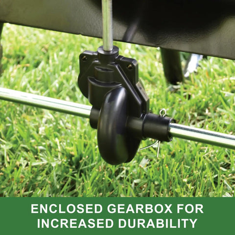 Close-up of 85 lb push rod broadcast spreader gearbox for durability, rustproof poly hopper, and direct rod gate on grass