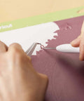 Cricut Basic Tool Set, 5-piece precision kit; white-handled tools on a pink cutting mat