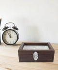 Wooden box on desk with vintage iron jewelry box latch hasps and clock