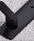 Close-up of Tough As Nails Wall Mounted Coat Hooks With Slick Black Finish, showcasing sturdy hook on textured fabric background.