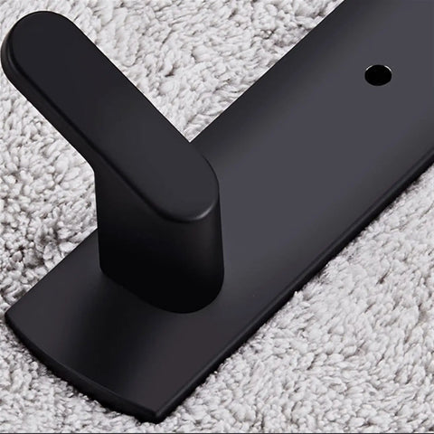 Close-up of Tough As Nails Wall Mounted Coat Hooks With Slick Black Finish, showcasing sturdy hook on textured fabric background.