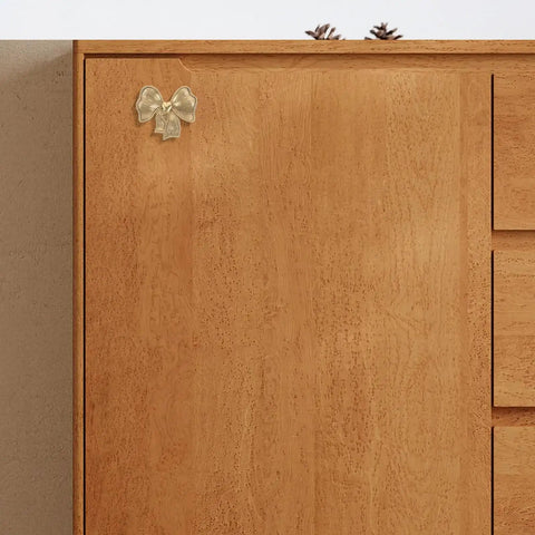 Luxurious Vintage Brass Bow Drawer Handles For Furniture And Boxes. Small gold bow pull on wooden cabinet door.